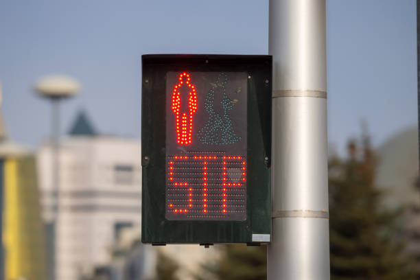 Stop sign. Black traffic light located within the city limits shows a red forbidding signal for crosswalk traffic.
