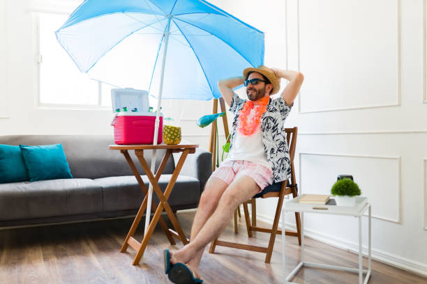 Cheerful man relaxing looking happy enjoying summer vacations at home