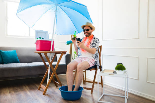 istock Happy man relaxing having a pedicure and a beer at home during summer 1490809064