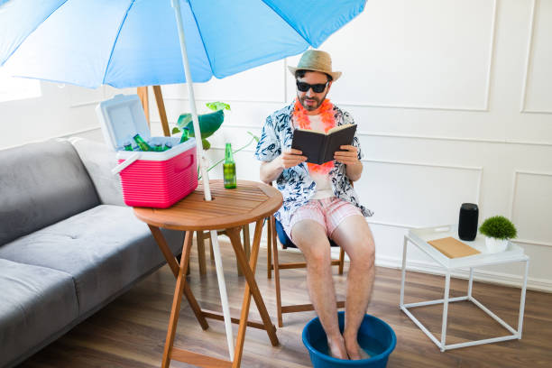 istock Handsome man relaxing with a book having summer staycations at home 1490809077