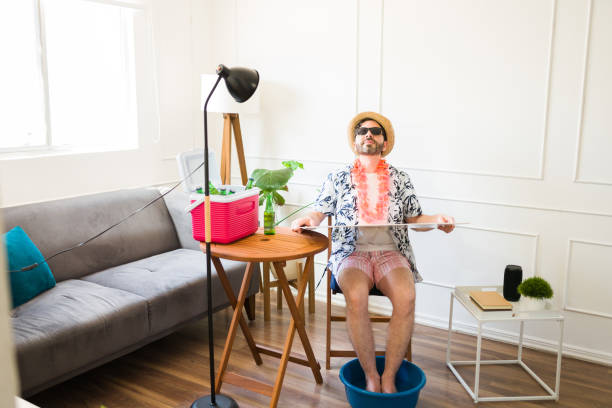 istock Relaxed caucasian man sunbathing and having a pedicure at home on vacations 1490809094