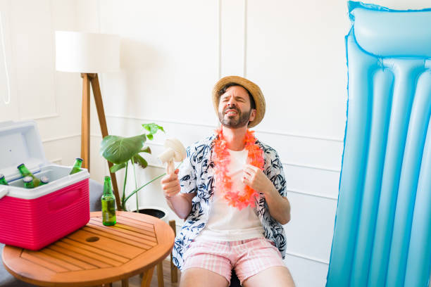 istock Hot man in his 40s using a fan and sweating at home during summer vacations 1490809128