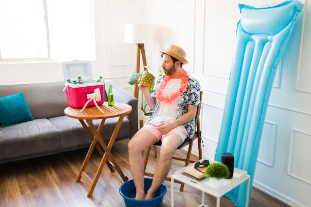 istock Latin man relaxing with a drink having a pedicure during his summer vacations at home 1490809134