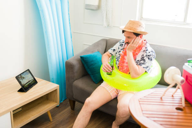 istock Annoyed caucasian man looking bored during his summer staycations at home 1490809863
