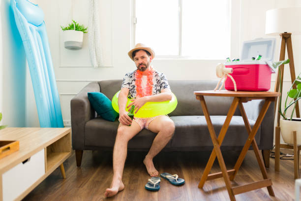 istock Annoyed man looking angry and lonely during his summer staycations at home 1490809897