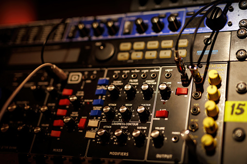 Sliders and knobs at an audio mixing console