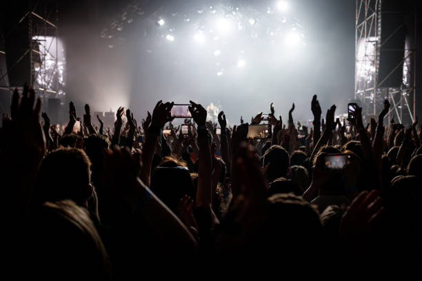 gente con las manos levantadas en un concierto de música. fans en sala de conciertos. - popular music concert stadium rock and roll crowd fotografías e imágenes de stock