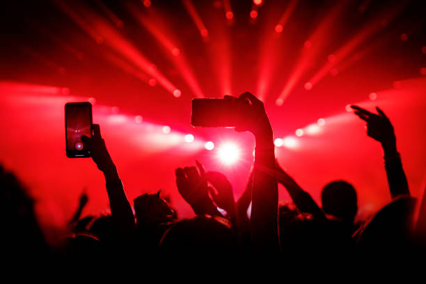 istock People at concert shooting video or photo using mobile phones. 1490811400