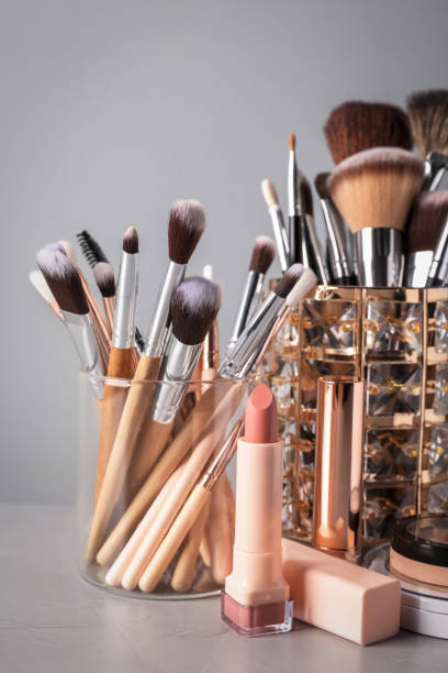 istock Set of professional brushes and makeup products on table against grey background 1490814300