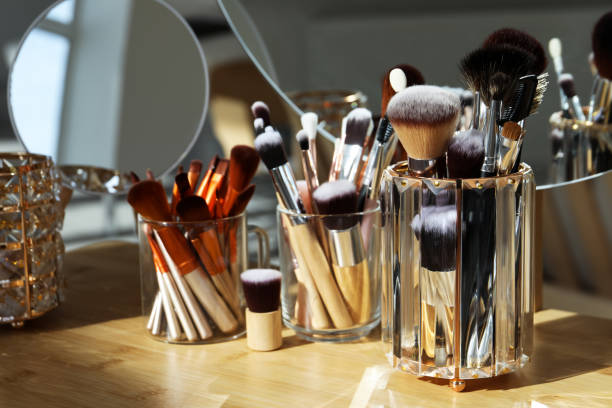 istock Set of professional brushes and mirror on wooden table 1490814395