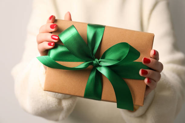 istock Christmas present. Woman holding gift box, closeup 1490814470