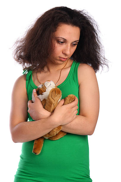 Curly-headed girl in green with toy stock photo