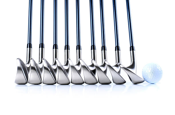 Set of golf club iron heads with a golf ball stock photo