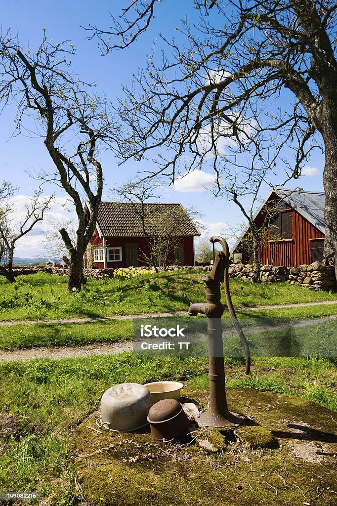 Old hand operated water pump Old hand operated water pump in the garden Agricultural Building Stock Photo