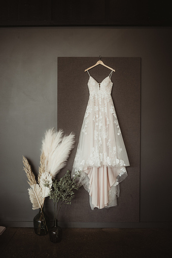 Lace wedding dress with pampas grass in a vase