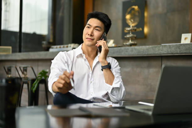 istock A businessman calling someone, talking on the phone while sitting in a coffee shop. 1490828652