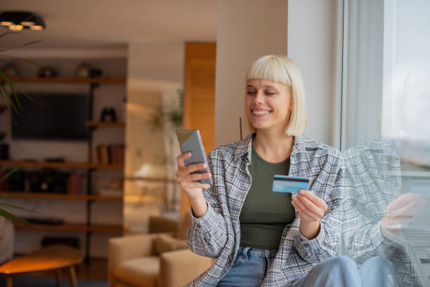 istock Cheerful  woman doing online shopping 1490831535