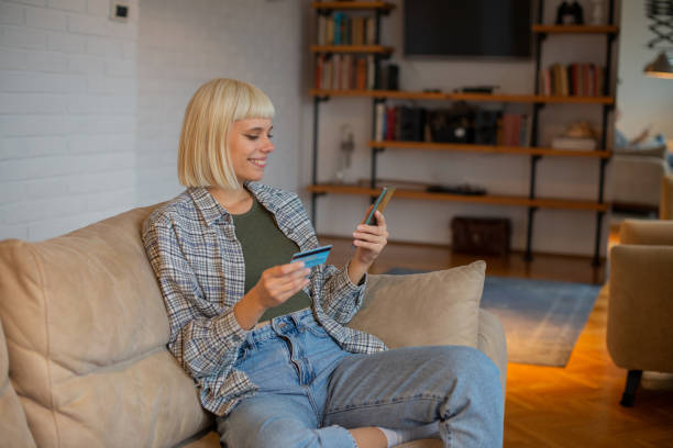 istock Cheerful  woman doing online shopping 1490831544