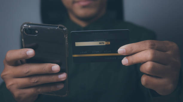 istock Businessman using mobile phone and credit card shopping online. 1490831708