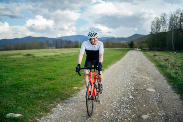 istock Active senior cycling on a cross country road. 1490832847