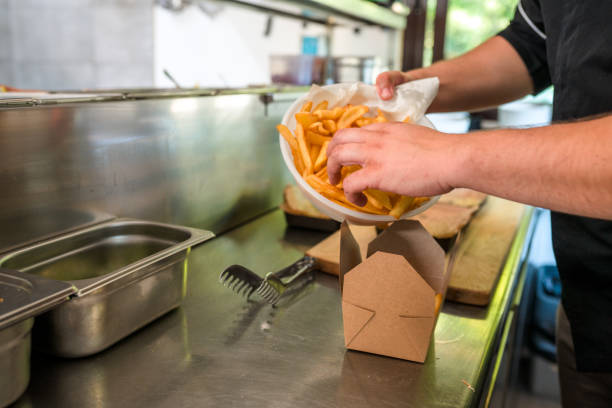 istock Fresh French Fries Being Placed on a To Go Box 1490835142