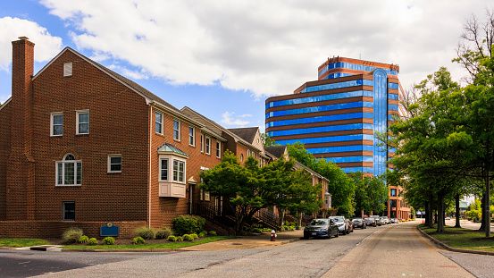 Street with small houses in Downtown district of small American town. University building in the distance, Hampton, Virginia