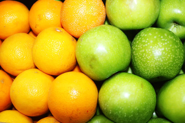 istock orange fruits and green apple close up image 1490837693