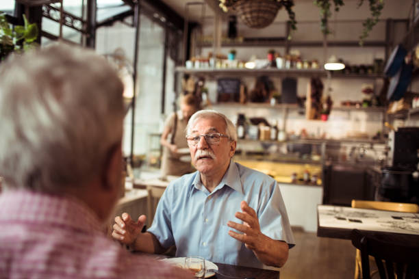 istock Two senior friends having a conversation at a local small restaurant 1490837794