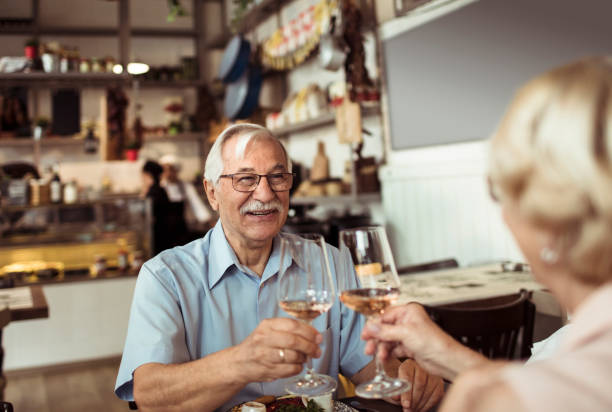 istock Senior couple enjoying a meal at a local small restaurant 1490838455