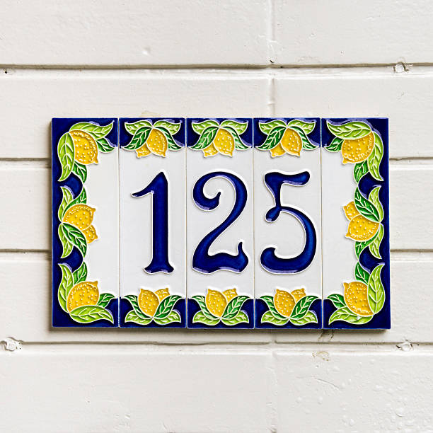 No. 125 house number hundred and twenty-five on ceramic tiles surrounded by a decoration of lemons ceramic tile house numbers stock pictures, royalty-free photos & images