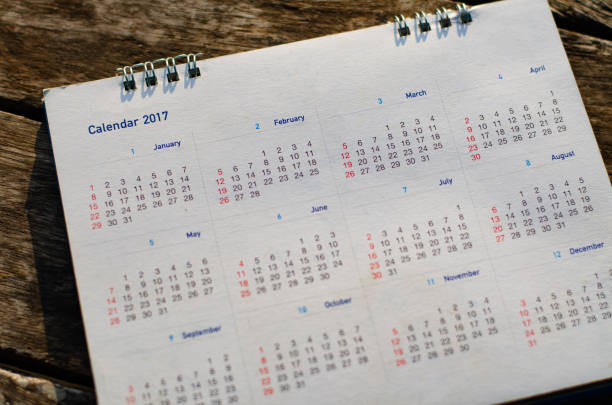 istock Old calendar page on wood background. 1490844543