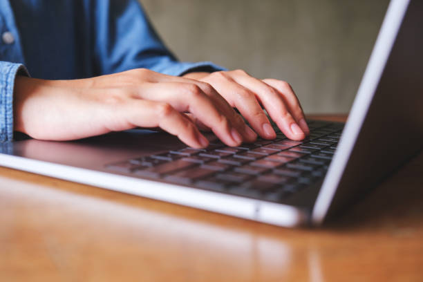 istock Closeup image of hands working and typing on laptop computer keyboard 1490847786