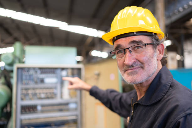 istock Senior engineer inspects the electrical system and repairs the mechanical system in the machine control cabinet. in order for the machine to return to normal operation 1490850391