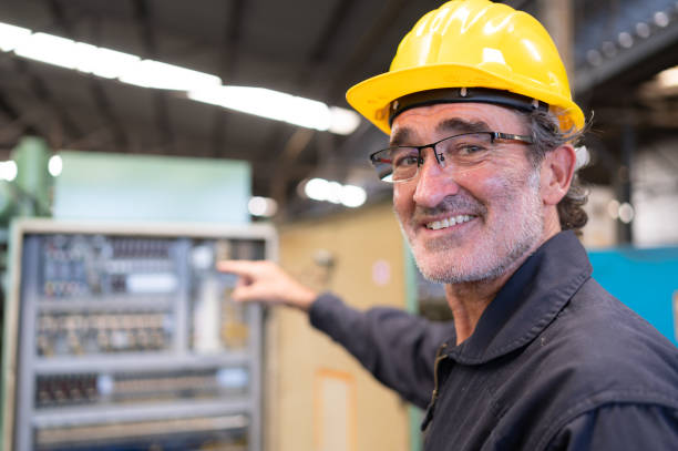 istock Senior engineer inspects the electrical system and repairs the mechanical system in the machine control cabinet. in order for the machine to return to normal operation 1490850393