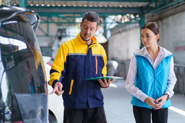 istock Woman and technician talking together in garage. 1490857491
