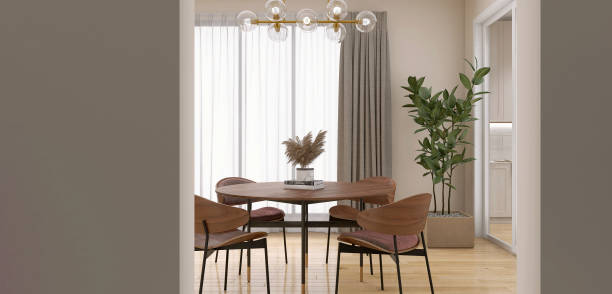 comedor de pared beige de lujo, mesa redonda de madera de estilo retro, silla, pata de acero negro, árbol tropical en suelo de parquet a la luz del sol desde la ventana, puerta a la cocina - sliding door hardwood floor dining room floor fotografías e imágenes de stock