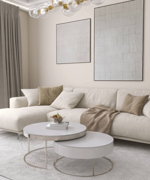 Two layer round white marble top coffee table, beige corner sofa on gray shag rug on marble floor in sunlight from sheer curtain window on beige wall luxury living room