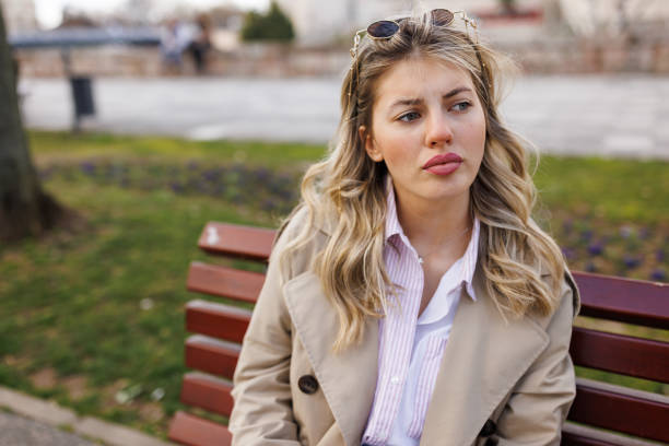 istock Young woman sitting on park bench 1490858829