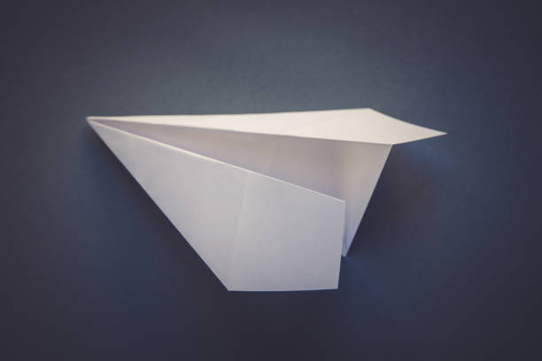 istock White paper plane origami isolated on a grey background 1490864935