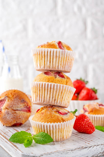 istock Homemade strawberry muffins or cupcakes on a board on a gray background. Selective focus. Copy space 1490872984