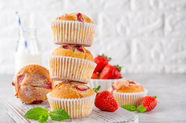 istock Homemade strawberry muffins or cupcakes on a board on a gray background. Selective focus. Copy space 1490872986