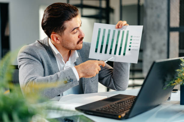 istock Businessman working in office with charts and graphs 1490875091