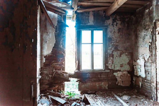 istock Horror abandoned creepy room with window. White light shines through the window.Horror scene.The nearby wall is badly cracked. 1490875173