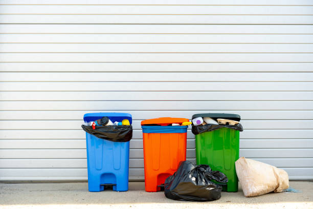istock Three trash containers full of garbage near the building 1490876677