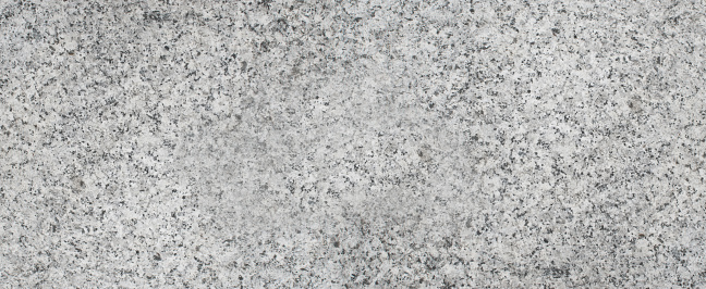 Gray granite stone background. Aged rough rock material texture top view