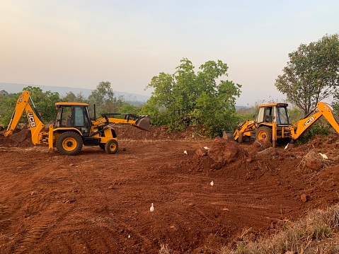 Chandgad, Kolhapur, Maharashtra, India: 19 march 2020.   JCB performing excavation work on the construction site