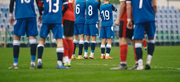 istock Soccer players standing in a wall during free kick 1490881613