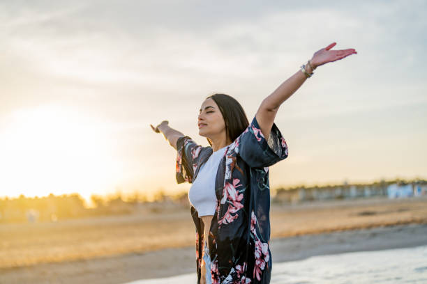 istock Woman with her arms raised to the sun 1490881773