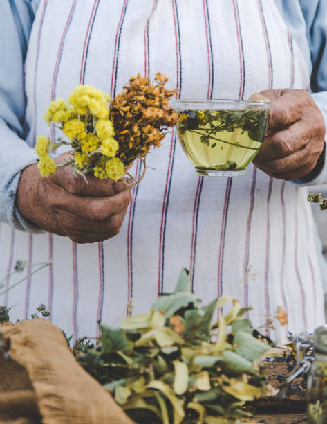 istock Grandmother makes tea with medicinal herbs. Selective focus. 1490881860