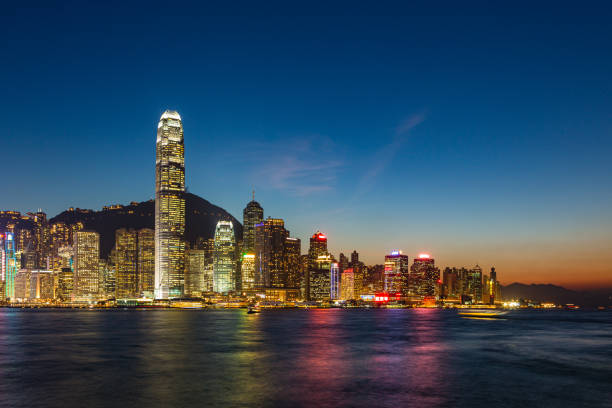 Night view of Hong Kong Victoria Harbour and Hong Kong Island Hong Kong is a Special Administrative Region of China located on the southern coast of China. It is known for its vibrant culture, beautiful skyline, and bustling economy. Hong Kong was a British colony until 1997 when it was handed back to China. Victoria Bay stock pictures, royalty-free photos & images